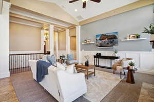 Living room featuring ornate columns, ceiling fan, a wainscoted wall, a decorative wall, and recessed lighting