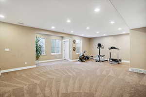 Exercise room featuring light colored carpet and recessed lighting