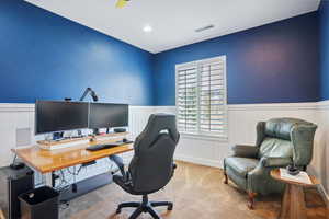 Home office with wainscoting and carpet