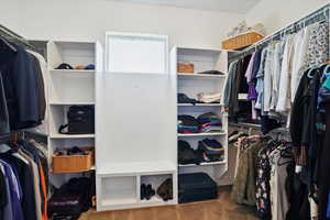 Walk in closet featuring carpet flooring