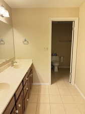 Bathroom featuring tile patterned floors and double vanity