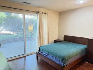 Bedroom with wood finished floors and access to exterior