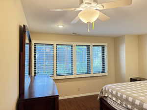 Bedroom featuring dark wood-type flooring, ceiling fan, and recessed lighting