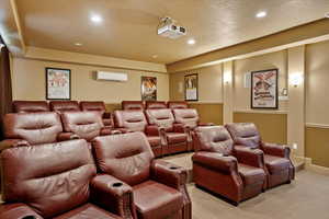 Home theater with light colored carpet, recessed lighting, wainscoting, and a wall unit AC