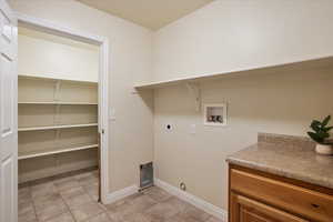 Washroom with hookup for a washing machine and electric dryer hookup