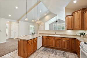 Kitchen featuring vaulted ceiling, white appliances, brown cabinets, light countertops, and recessed lighting
