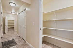 Hall featuring light tile patterned flooring