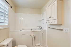 Bathroom featuring toilet and a bath