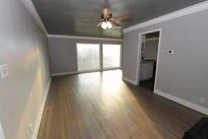 Unfurnished room featuring ceiling fan, dark wood finished floors, and ornamental molding