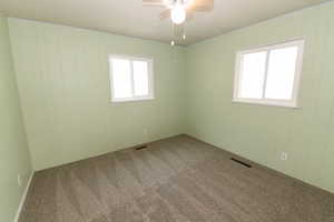 Spare room with carpet floors and a ceiling fan