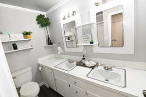 Full bath featuring double vanity and toilet