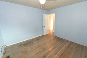 Spare room with light wood-style flooring and ceiling fan