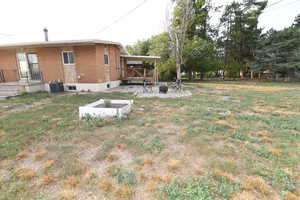 View of green lawn with a fire pit