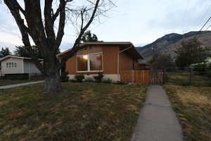 View of front of property with a mountain view and brick siding