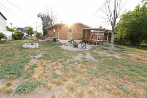 View of yard featuring a wooden deck and a fire pit