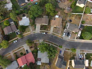 Aerial view of property's location with nearby suburban area