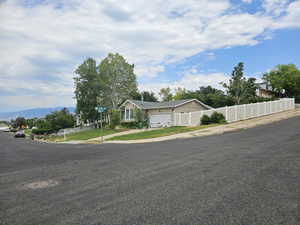 View of front of house featuring an attached garage, driveway, and a mountain view