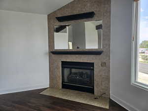 Detailed view of wood finished floors and a fireplace