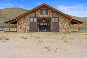 View of barn with a mountain view