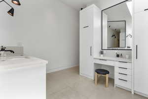 Bathroom with vanity and baseboards