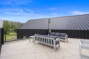 View of patio / terrace with an outdoor living space and a mountain view