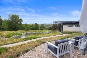 View of yard with a patio and a water and mountain view