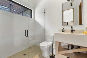 Bathroom featuring plenty of natural light, a stall shower, vanity, and tile patterned floors