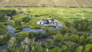 Aerial view of property and surrounding area featuring a large body of water and rural landscape
