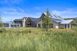 View of front of property with a metal roof and stone siding