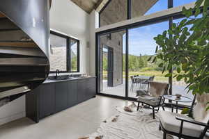 Doorway featuring concrete floors and a high ceiling