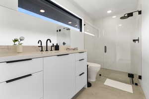 Bathroom featuring vanity, a stall shower, and recessed lighting