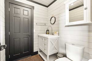 Bathroom featuring vanity and wood walls
