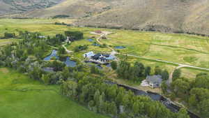 Aerial view of property and surrounding area featuring a nearby body of water