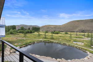 Water view featuring a mountain backdrop and rural landscape