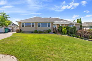 View of front of property featuring a pergola and brick siding