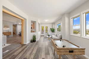 Recreation room with wood finished floors and baseboards