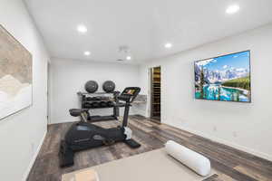 Workout area with recessed lighting and wood finished floors