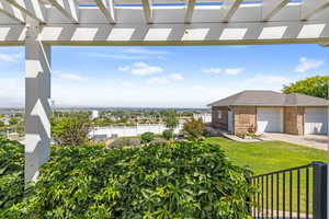 View of yard with a pergola, concrete driveway, and a garage