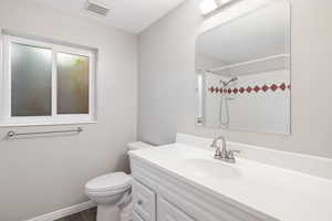 Bathroom with vanity, a shower, and wood finished floors