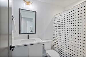 Full bathroom with vanity and curtained shower