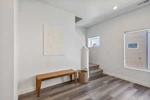 Foyer featuring stairway, wood finished floors, and recessed lighting