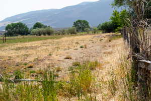 View of mountain backdrop featuring rural landscape