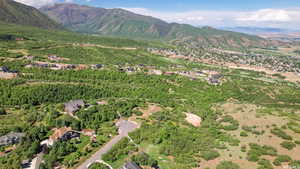 Aerial view of property and surrounding area with a mountain backdrop