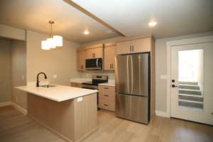 This kitchen features full appliance package. Microwave, Dishwasher, Range, Fridge, pantry, with nice cabinets and Quartz countertops. Pull out faucet and garbage disposal.