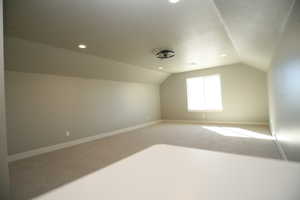 Bonus room with carpet flooring, lofted ceiling, recessed lighting, This space is large and spacious you will love the views.