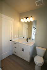 Bathroom with vanity and full bathtub/shower with tile to the ceilings.