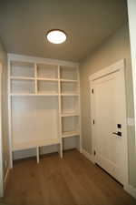 Mudroom featuring dark wood-style flooring and baseboards
