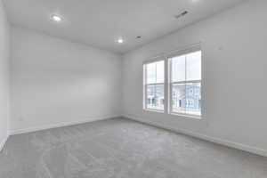 Unfurnished room featuring recessed lighting and carpet flooring
