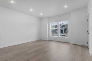 Spare room featuring light wood finished floors and recessed lighting