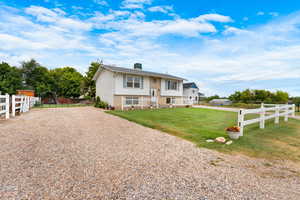 Bi-level home with a gravel driveway